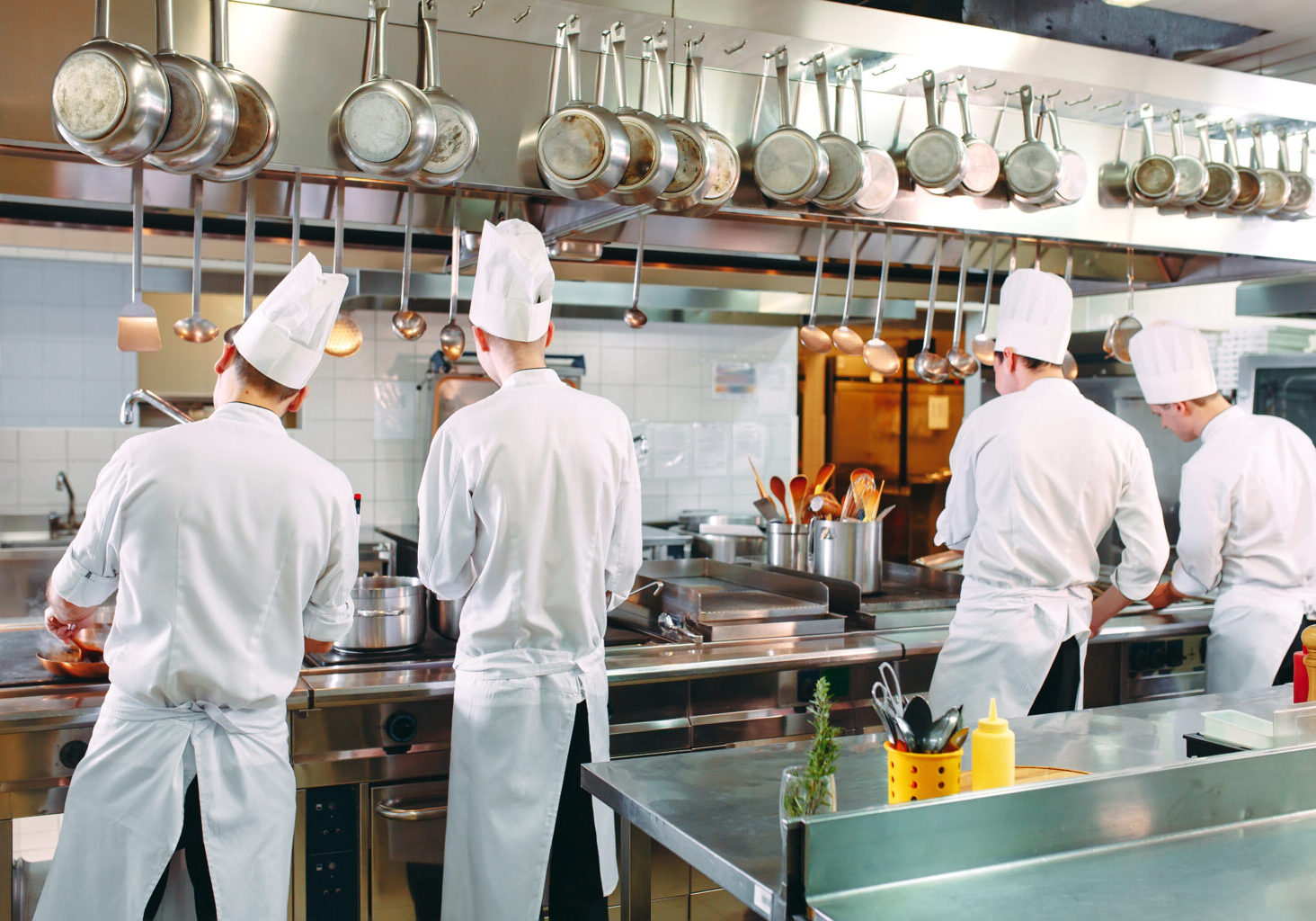 Modern kitchen. Cooks prepare meals on the stove in the kitchen of the restaurant or hotel. The fire in the kitchen