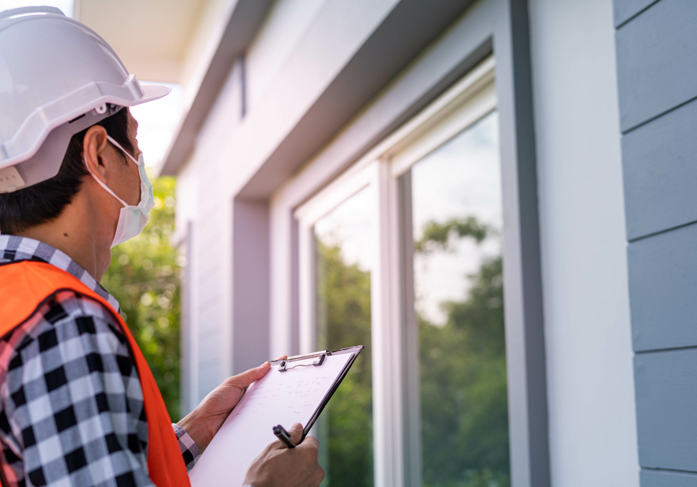 Inspector or engineer is checking and inspecting the building or house by using checklist. Engineers and architects work on building the house before handing it over to the landlord.